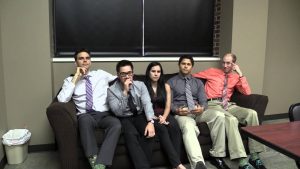 Five Doctors sitting on a couch in a green room