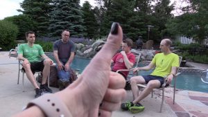 Womens thumb, group of guys, and a pool