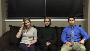 Three people sitting on a couch